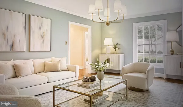 a living room with furniture and a chandelier
