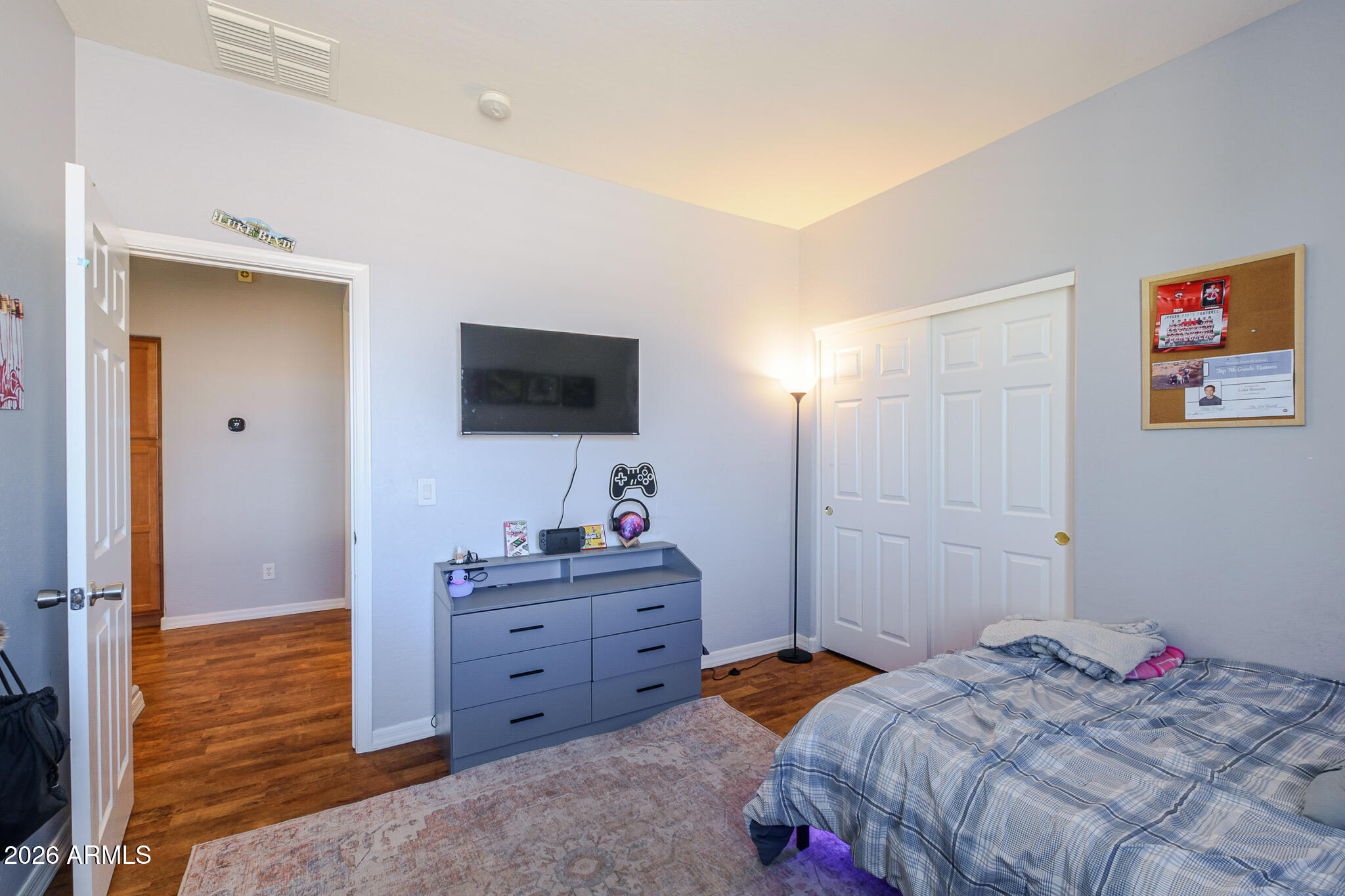 4521 West Moss Springs Road Anthem, AZ 85086 - Photo 31 of 35 a bedroom with a bed and a flat screen tv