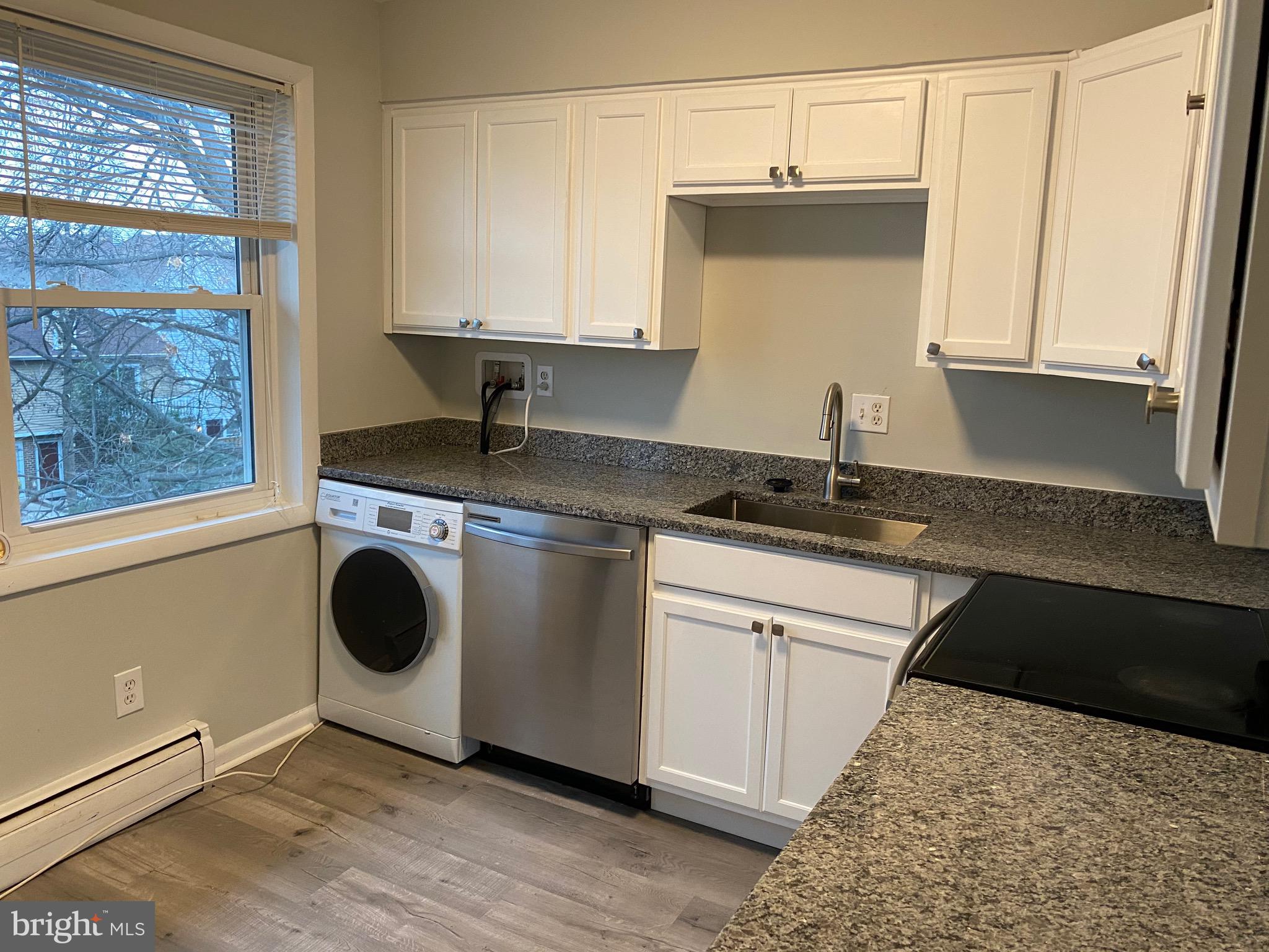 4256 Buckman Road, Unit 27 Alexandria, VA 22309 - Photo 15 of 30 a kitchen with a stove a sink and a microwave