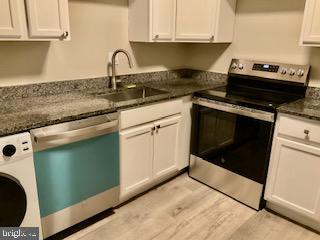4256 Buckman Road, Unit 27 Alexandria, VA 22309 - Photo 18 of 30 a kitchen with granite countertop a stove and a sink