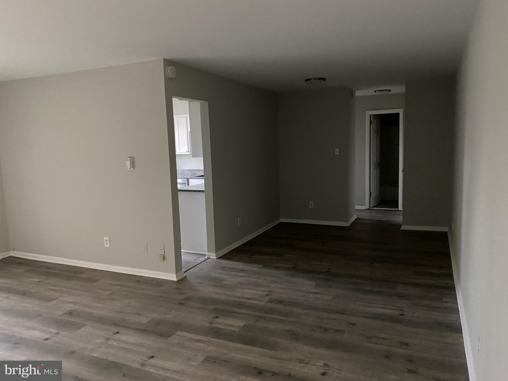 4256 Buckman Road, Unit 27 Alexandria, VA 22309 - Photo 20 of 30 an empty room with wooden floor and windows