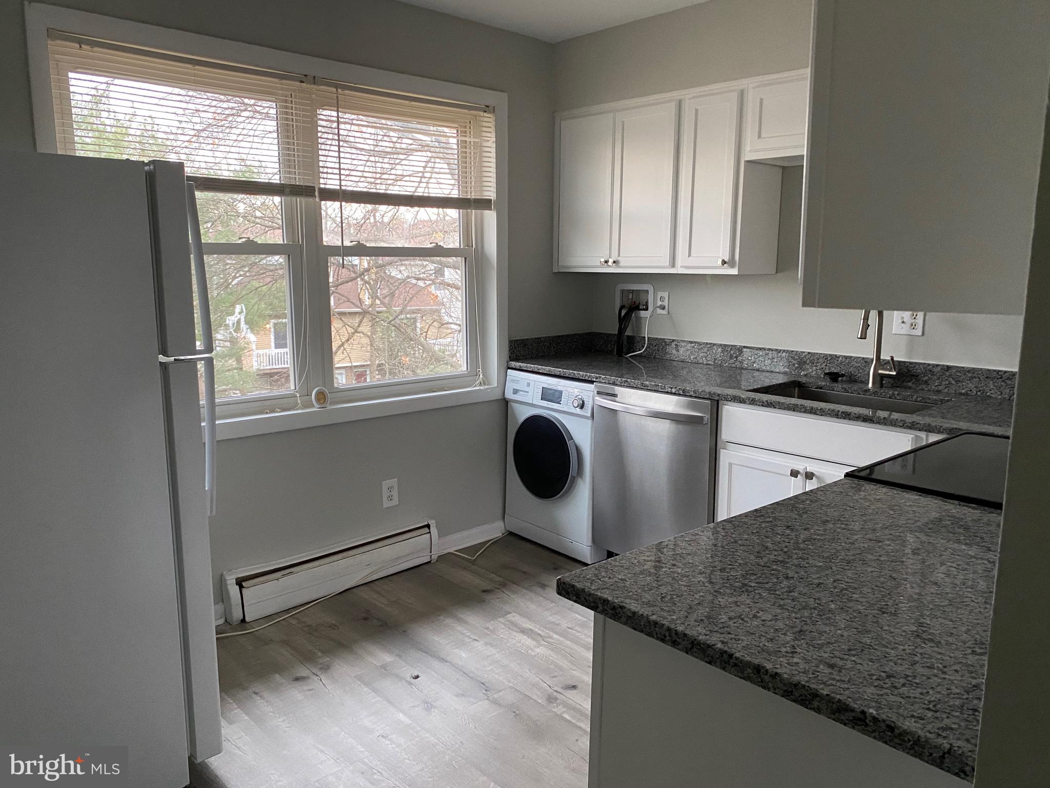 4256 Buckman Road, Unit 27 Alexandria, VA 22309 - Photo 22 of 30 a kitchen with granite countertop a sink a stove and cabinets