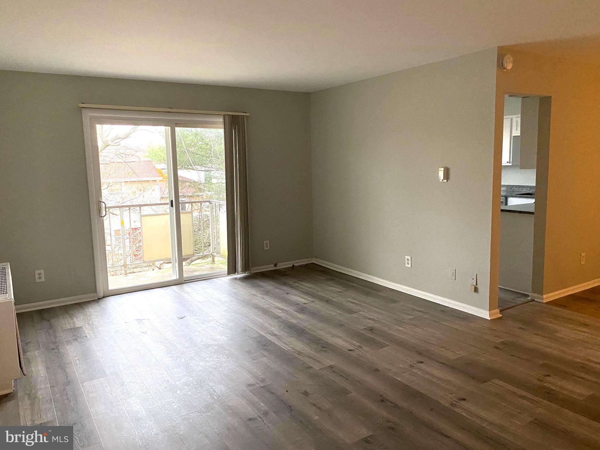 4256 Buckman Road, Unit 27 Alexandria, VA 22309 - Photo 8 of 30 an empty room with wooden floor and windows