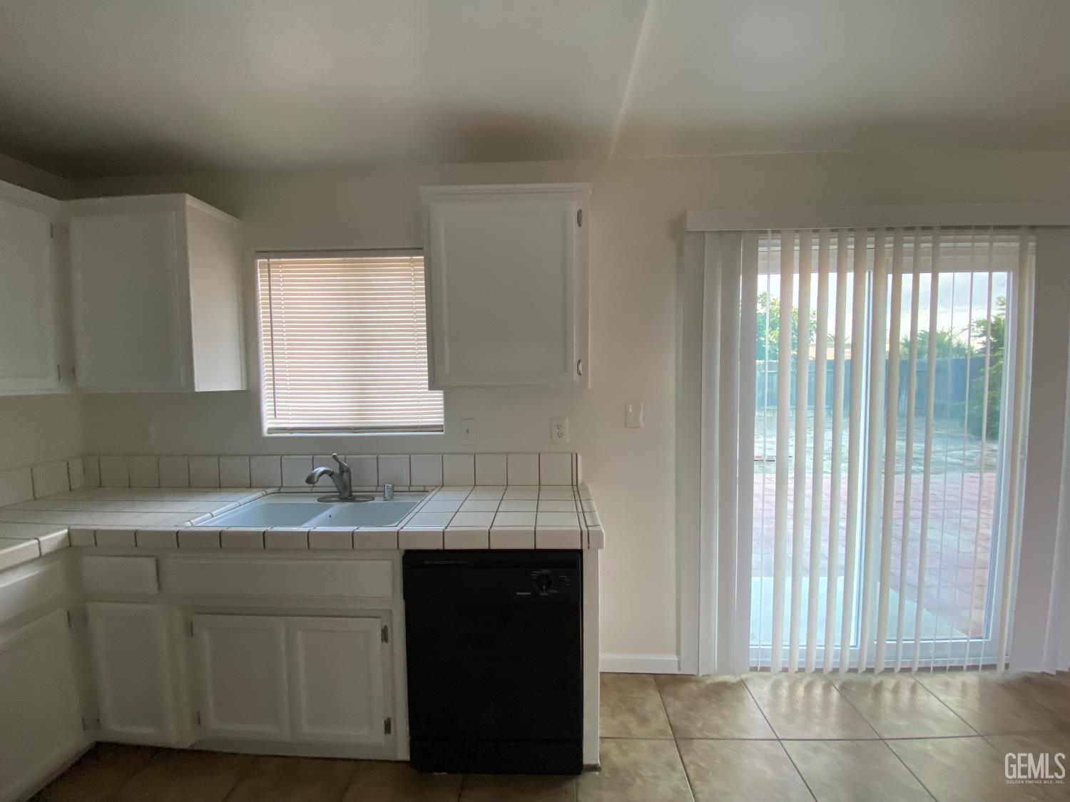 Undisclosed Address Bakersfield, CA 93307 - Photo 14 of 34 a kitchen with a sink and cabinets