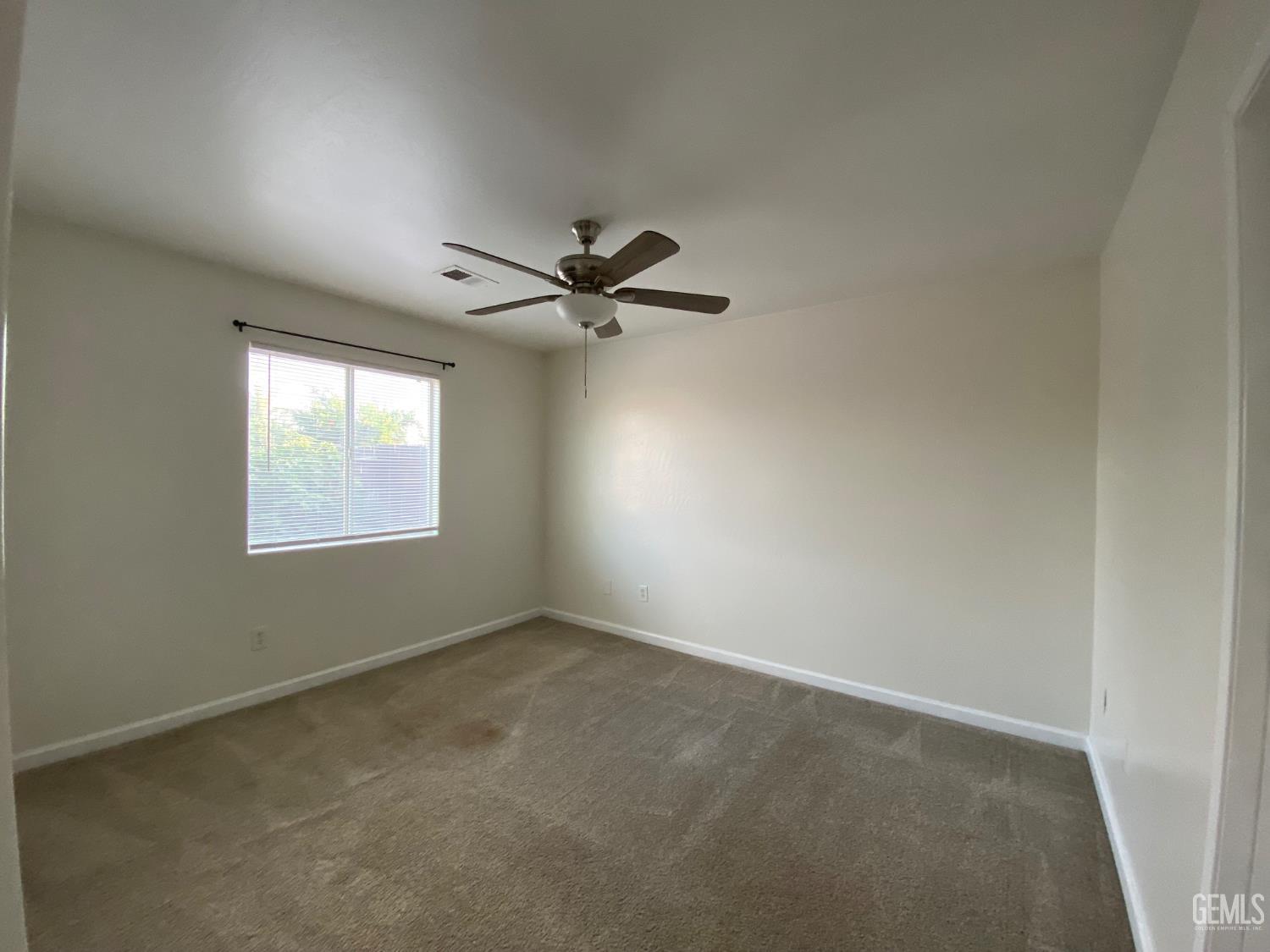 Undisclosed Address Bakersfield, CA 93307 - Photo 19 of 34 a view of an empty room with a window