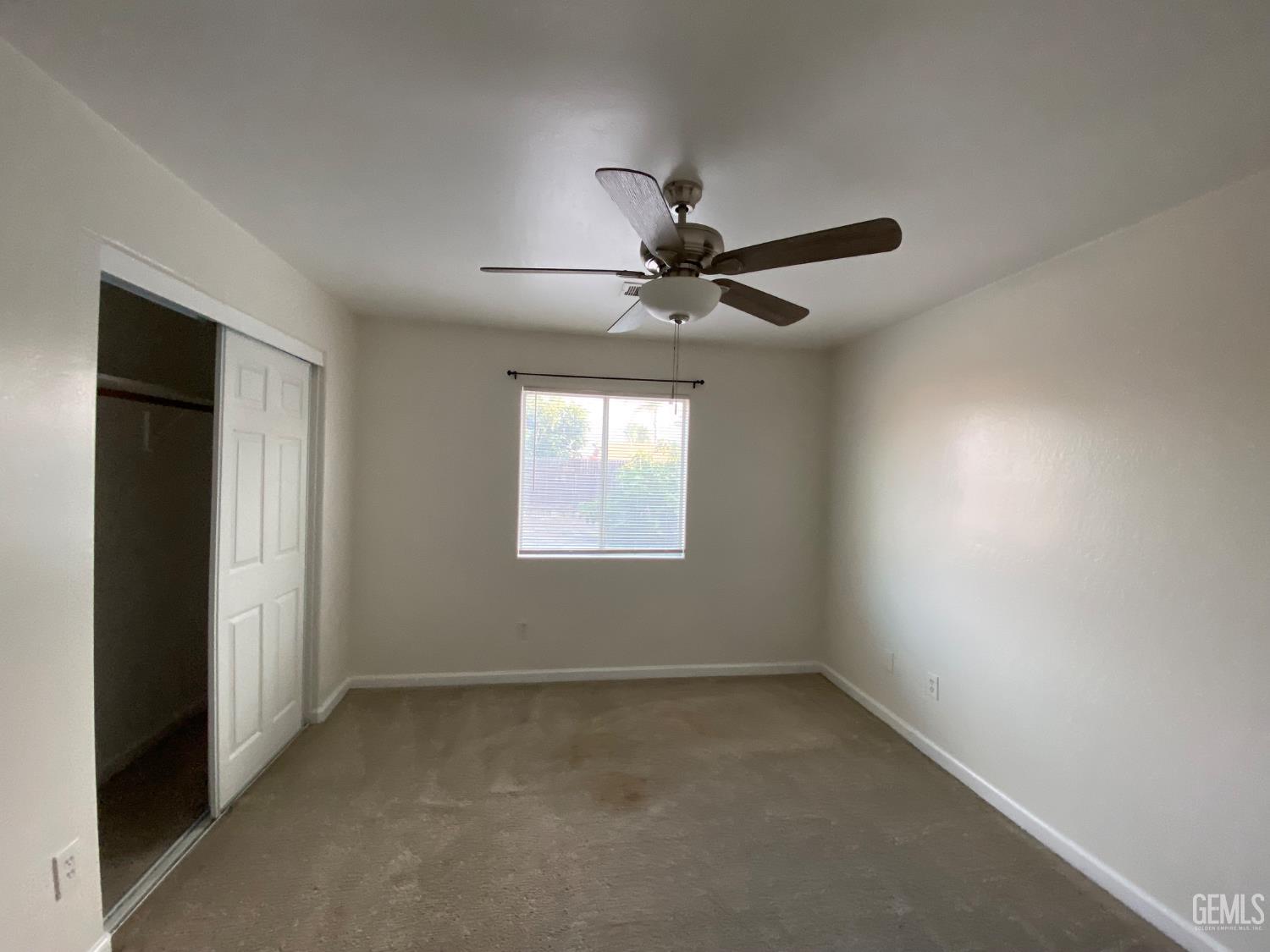 Undisclosed Address Bakersfield, CA 93307 - Photo 20 of 34 an empty room with a window and a fan