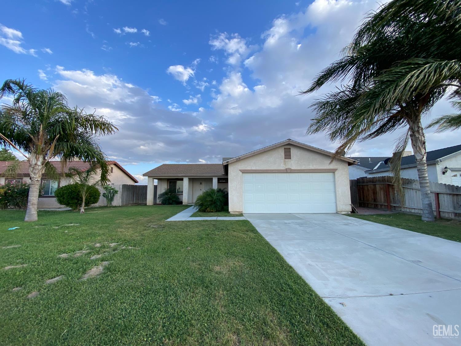 Undisclosed Address Bakersfield, CA 93307 - Photo 2 of 34 a front view of house with yard and green space