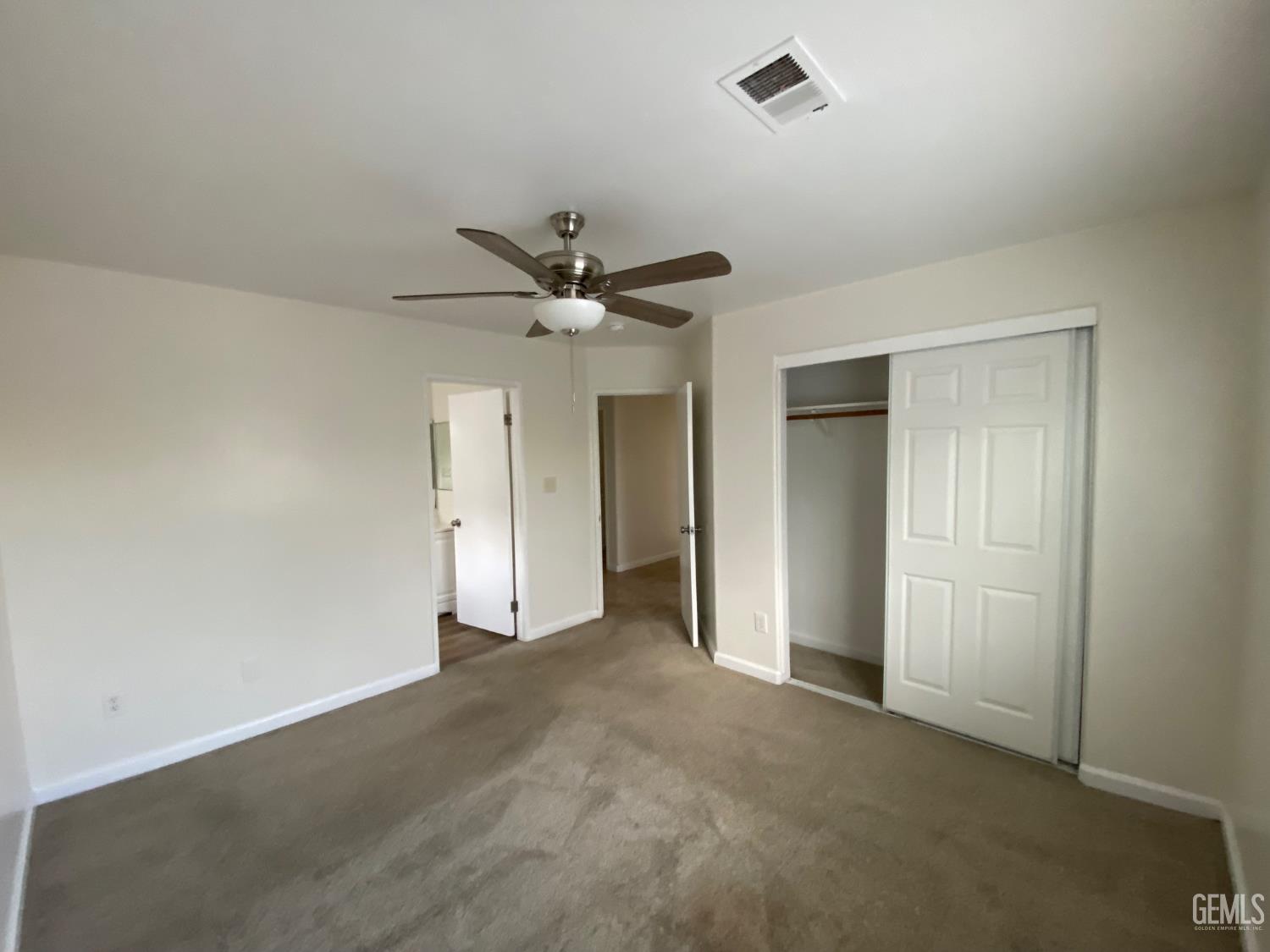 Undisclosed Address Bakersfield, CA 93307 - Photo 21 of 34 an empty room with a ceiling fan and a window
