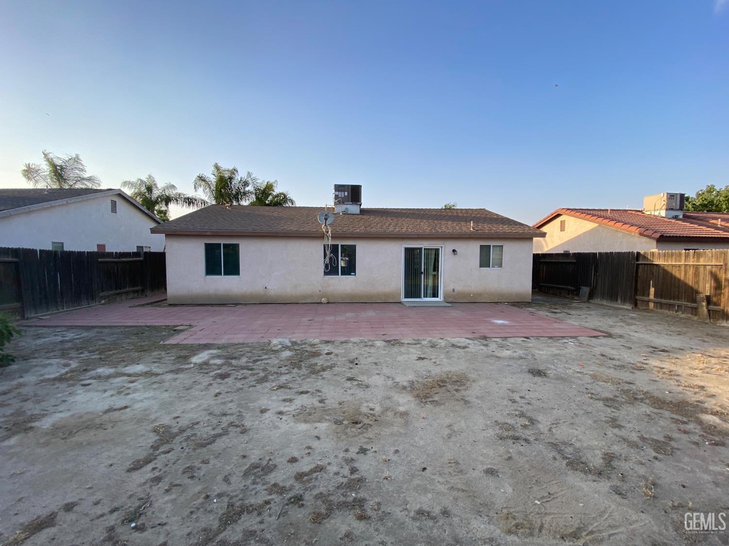 Undisclosed Address Bakersfield, CA 93307 - Photo 34 of 34 a front view of a house with a yard and parking