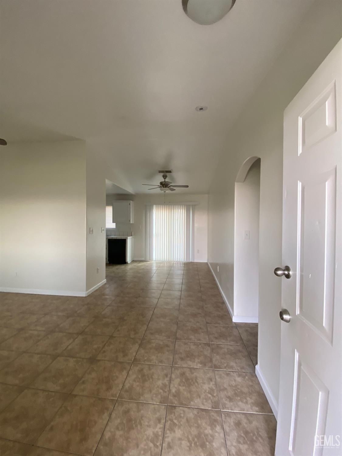 Undisclosed Address Bakersfield, CA 93307 - Photo 4 of 34 a view of a hallway to an empty room and a window