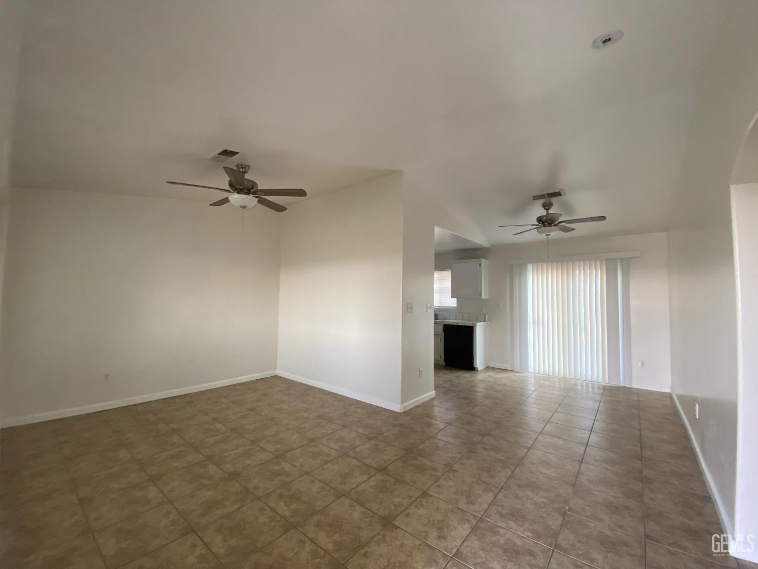 Undisclosed Address Bakersfield, CA 93307 - Photo 5 of 34 an empty room with fan and windows