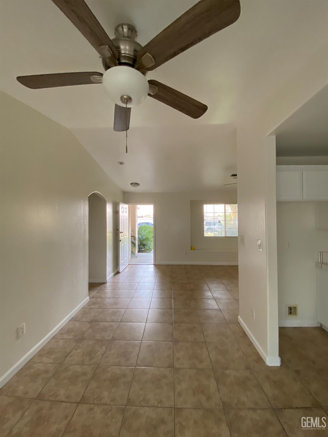 Undisclosed Address Bakersfield, CA 93307 - Photo 10 of 34 a view of a hallway with a chandelier fan and windows