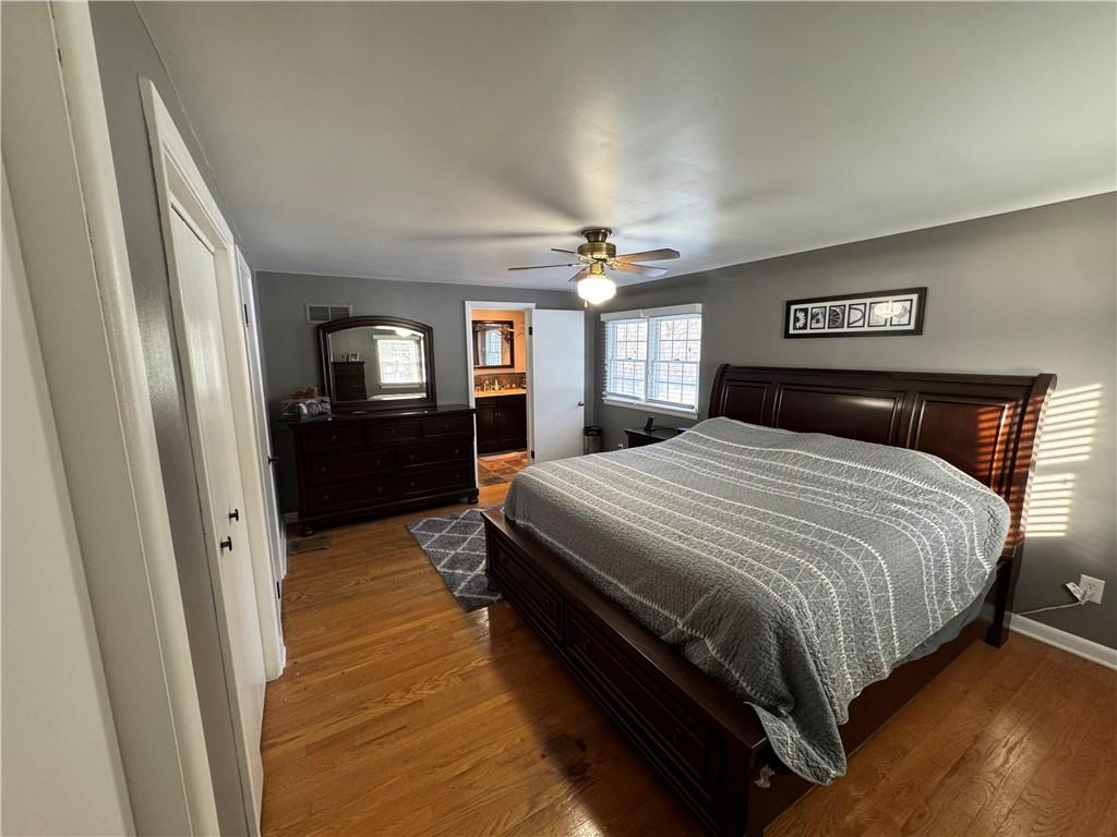 2072 Boyd School Road Wampum, PA 16157 - Photo 15 of 45 a bedroom with a bed and wooden floor