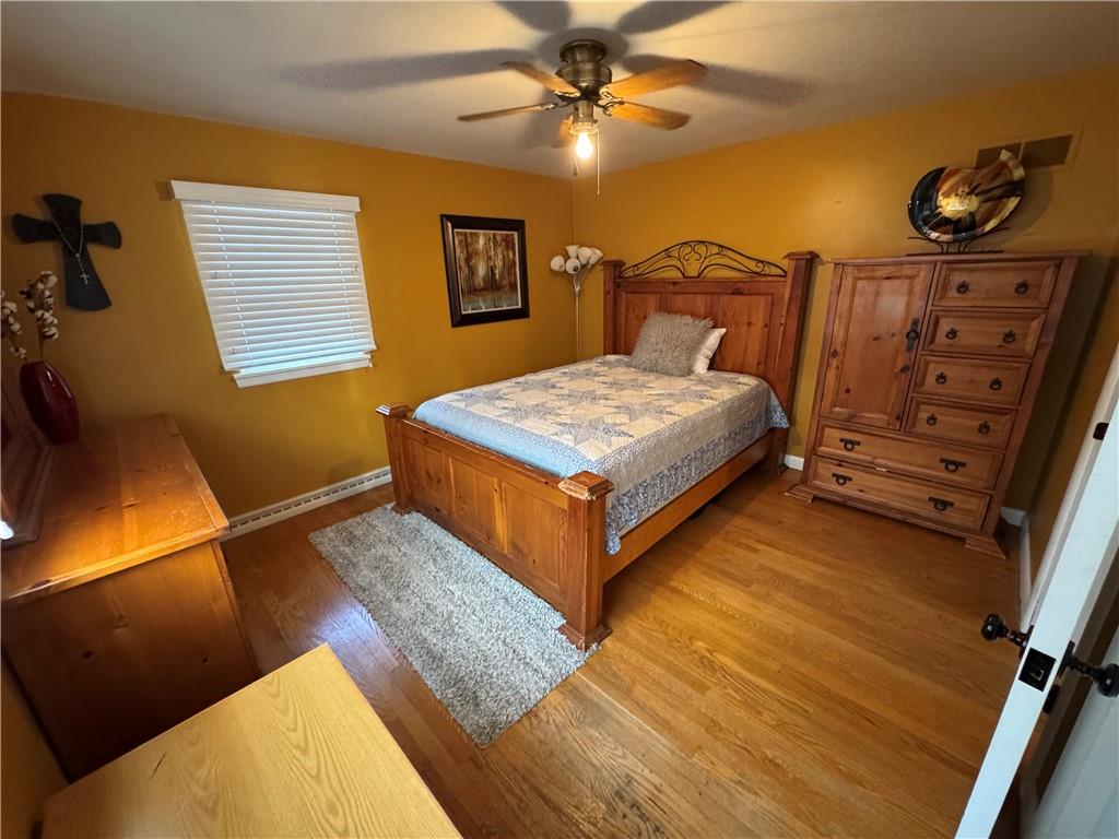 2072 Boyd School Road Wampum, PA 16157 - Photo 20 of 45 a bedroom with a bed and wooden floor