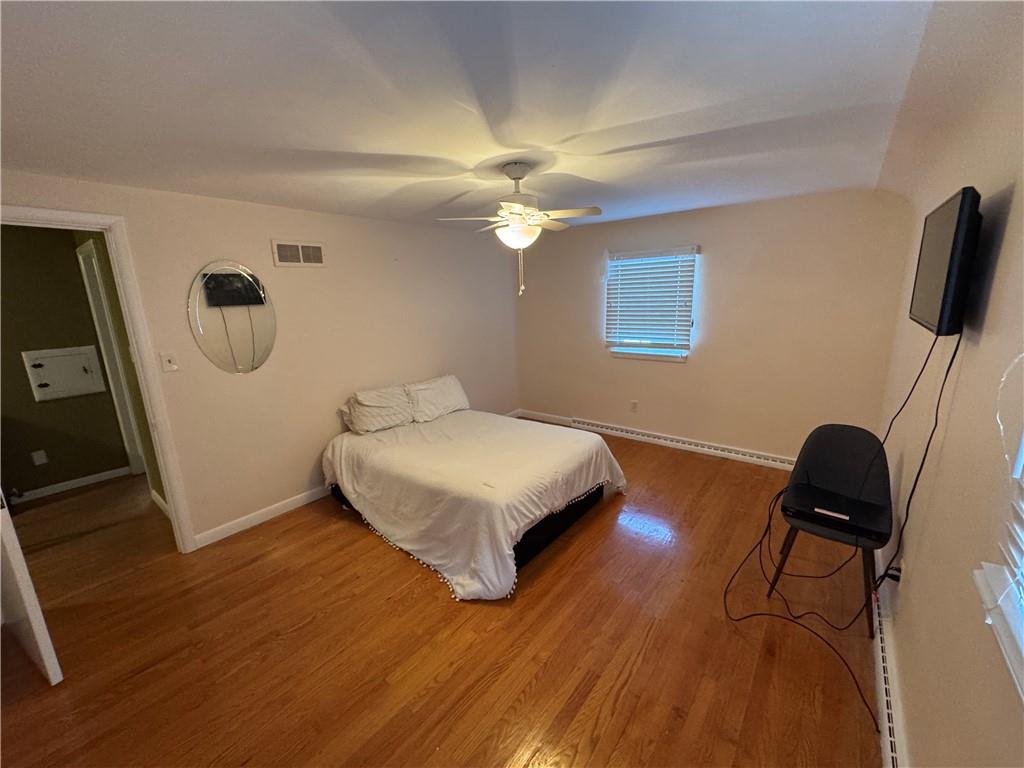 2072 Boyd School Road Wampum, PA 16157 - Photo 21 of 45 a bedroom with a bed and wooden floor