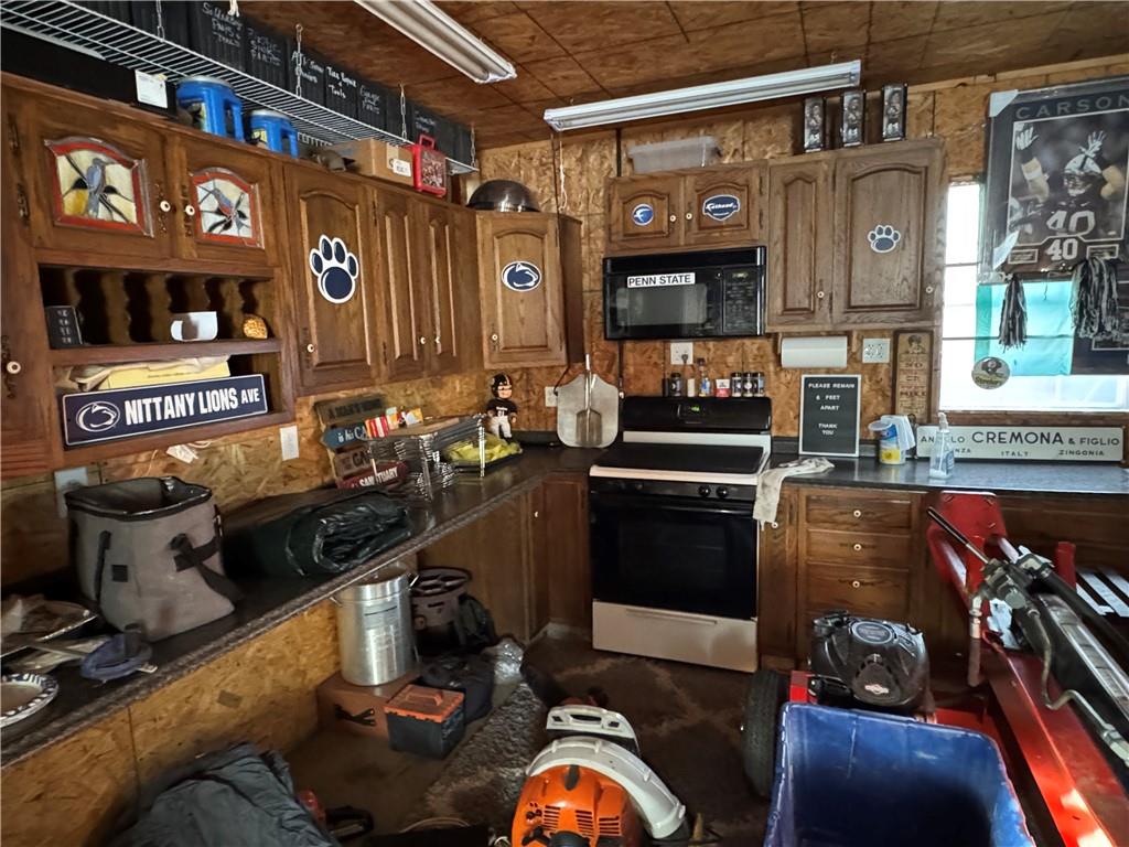 2072 Boyd School Road Wampum, PA 16157 - Photo 38 of 45 a kitchen with stainless steel appliances granite countertop a stove and cabinets