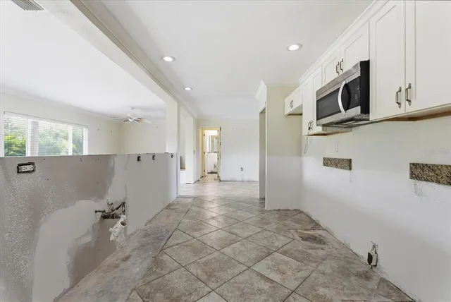 a view of a kitchen with a sink and a refrigerator