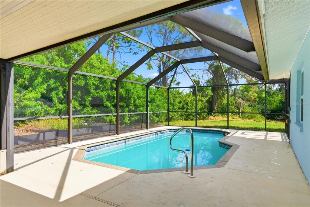 229 Stratford Road Englewood, FL 34223 - Photo 2 of 49 a swimming pool with an outdoor seating yard