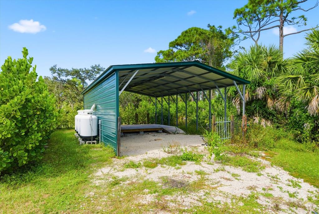 229 Stratford Road Englewood, FL 34223 - Photo 3 of 49 a view of a chair under an umbrella