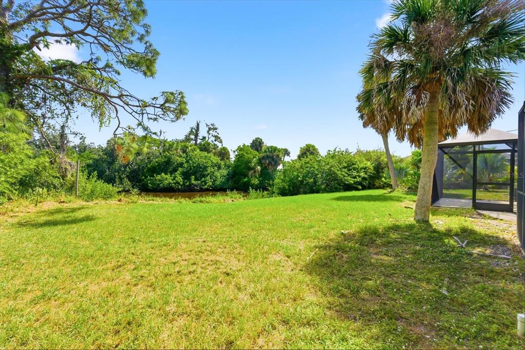 229 Stratford Road Englewood, FL 34223 - Photo 34 of 49 a view of a yard with a palm tree