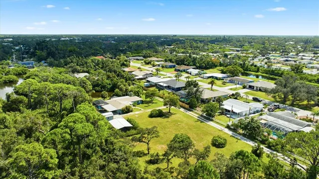 an aerial view of residential house with swimming pool and outdoor space