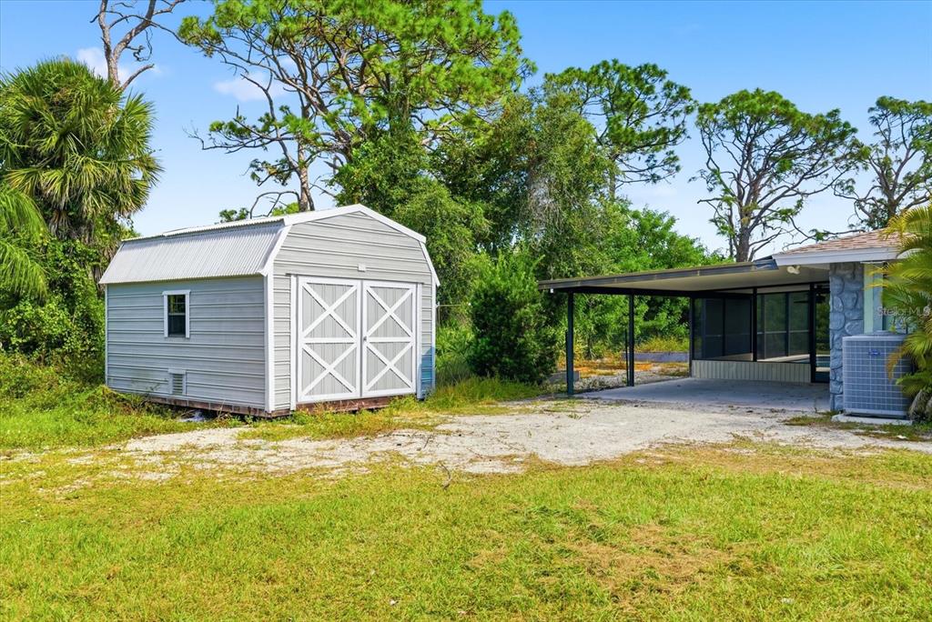 229 Stratford Road Englewood, FL 34223 - Photo 4 of 49 a view of a house with a backyard and a tree