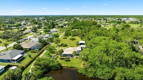 a view of a city with lush green forest