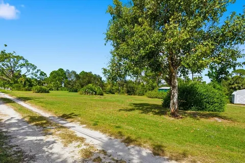 a view of a field with an trees in the background