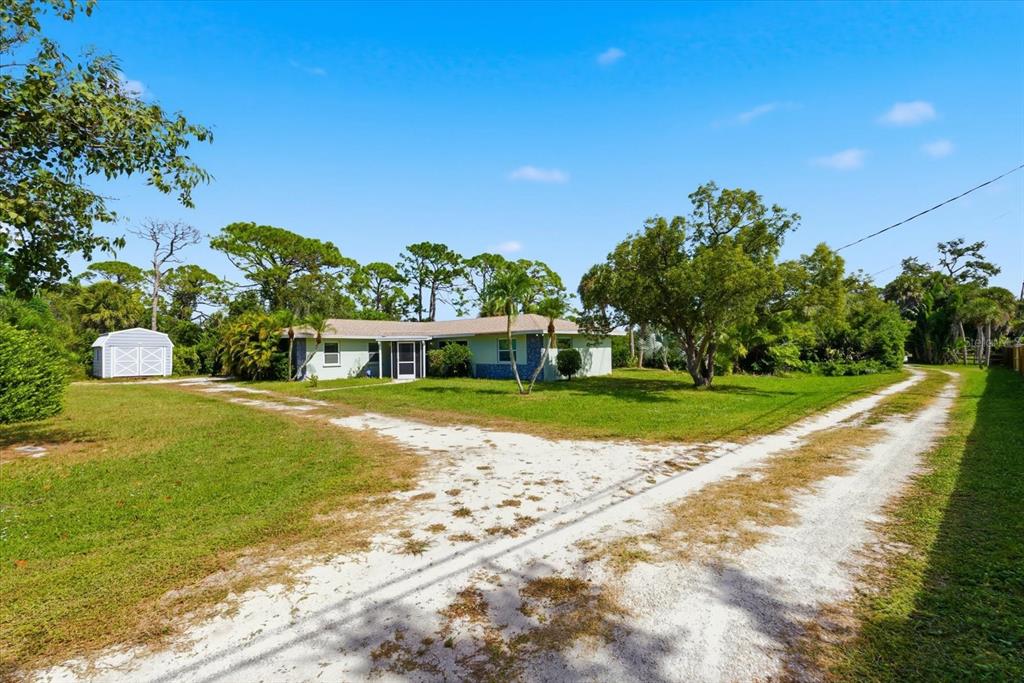 229 Stratford Road Englewood, FL 34223 - Photo 7 of 49 a view of building with garden