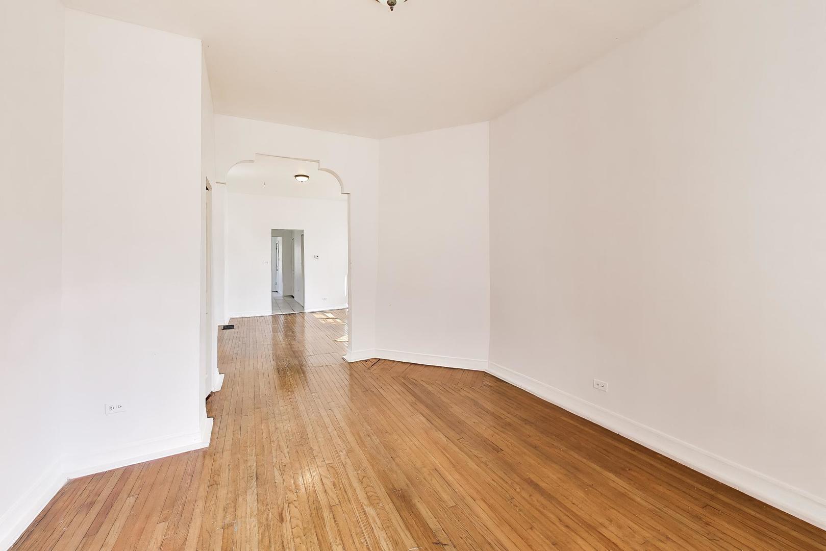6853 South Perry Avenue Chicago, IL 60621 - Photo 4 of 28 a view of a room with wooden floor and brick wall