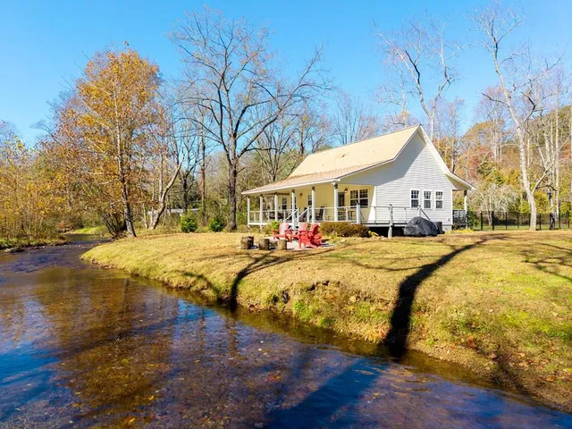 a swimming pool with outdoor seating and yard