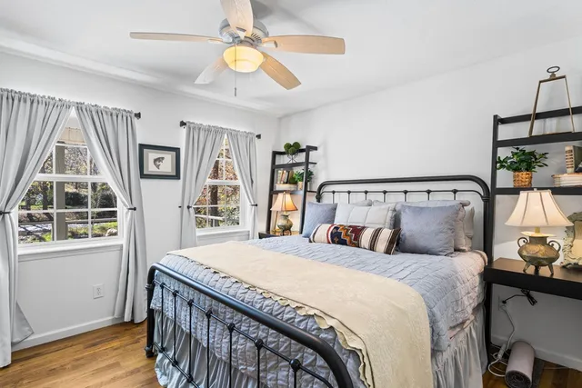 a bedroom with a large bed and a window