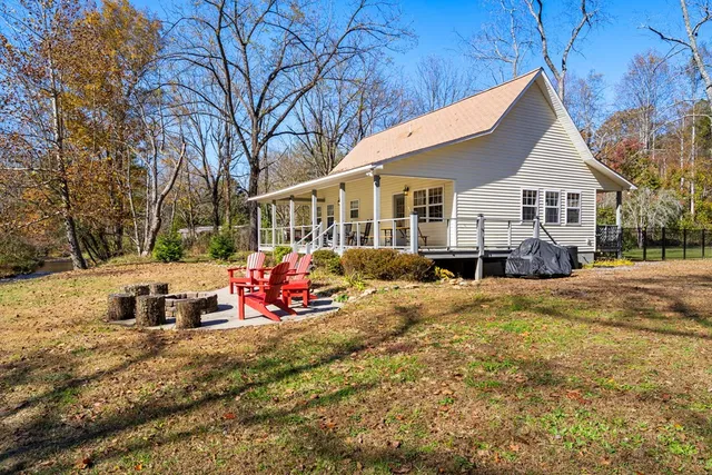 a view of a house with a yard covered in snow