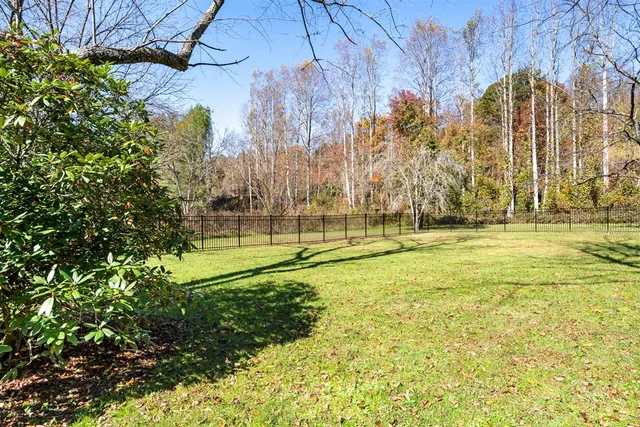 a view of a yard with swimming pool