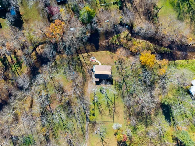 a aerial view of a house with a yard