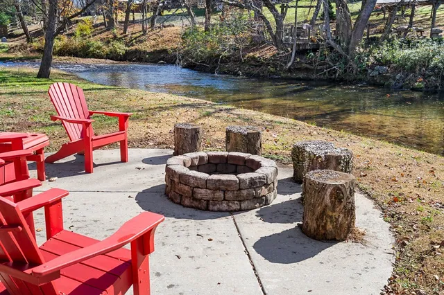 a view of a swimming pool with a patio and a lake view