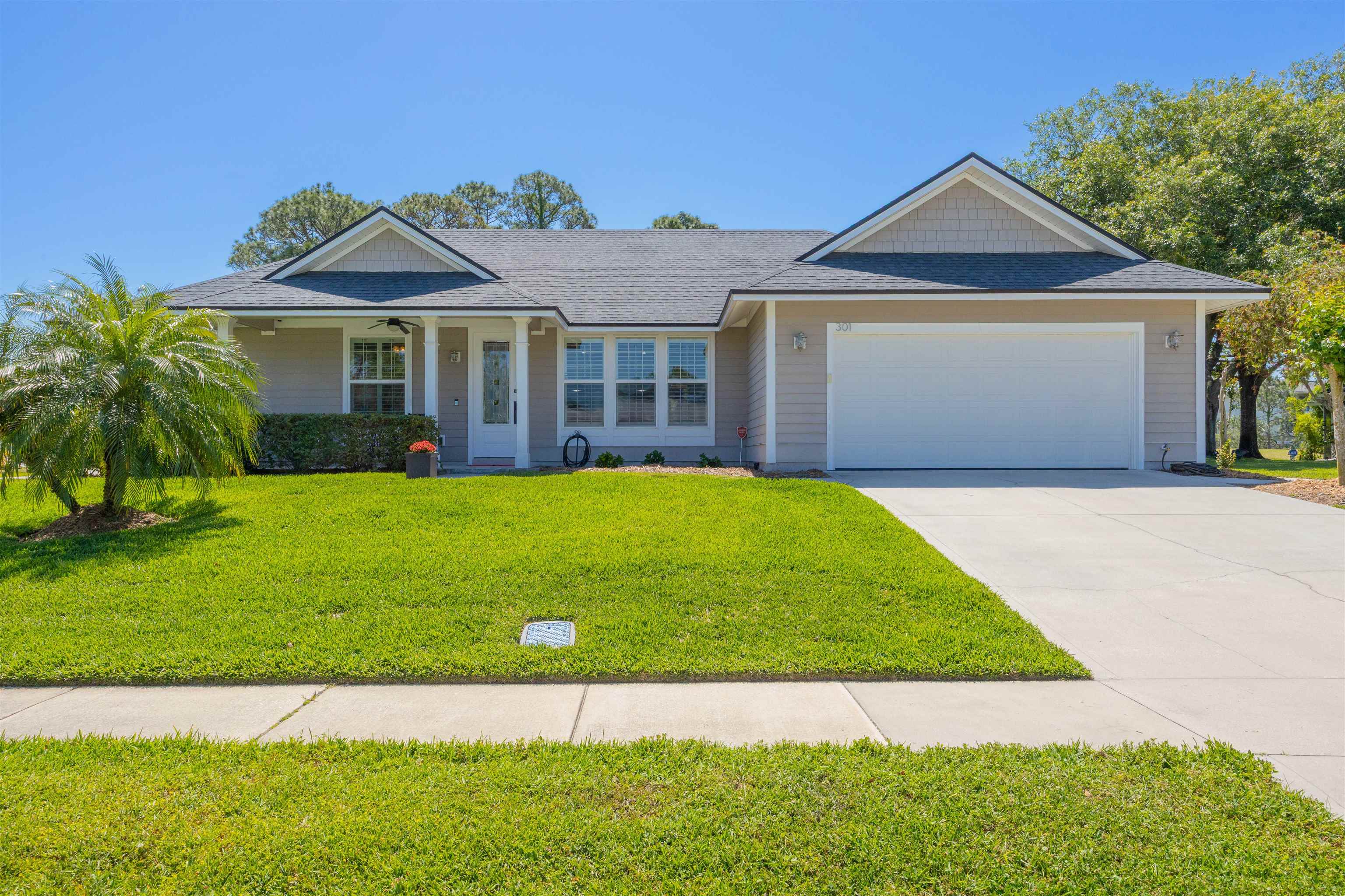 301 Graciela Circle St. Augustine, FL 32086 - Photo 2 of 84 a view of a white house with a big yard and potted plants