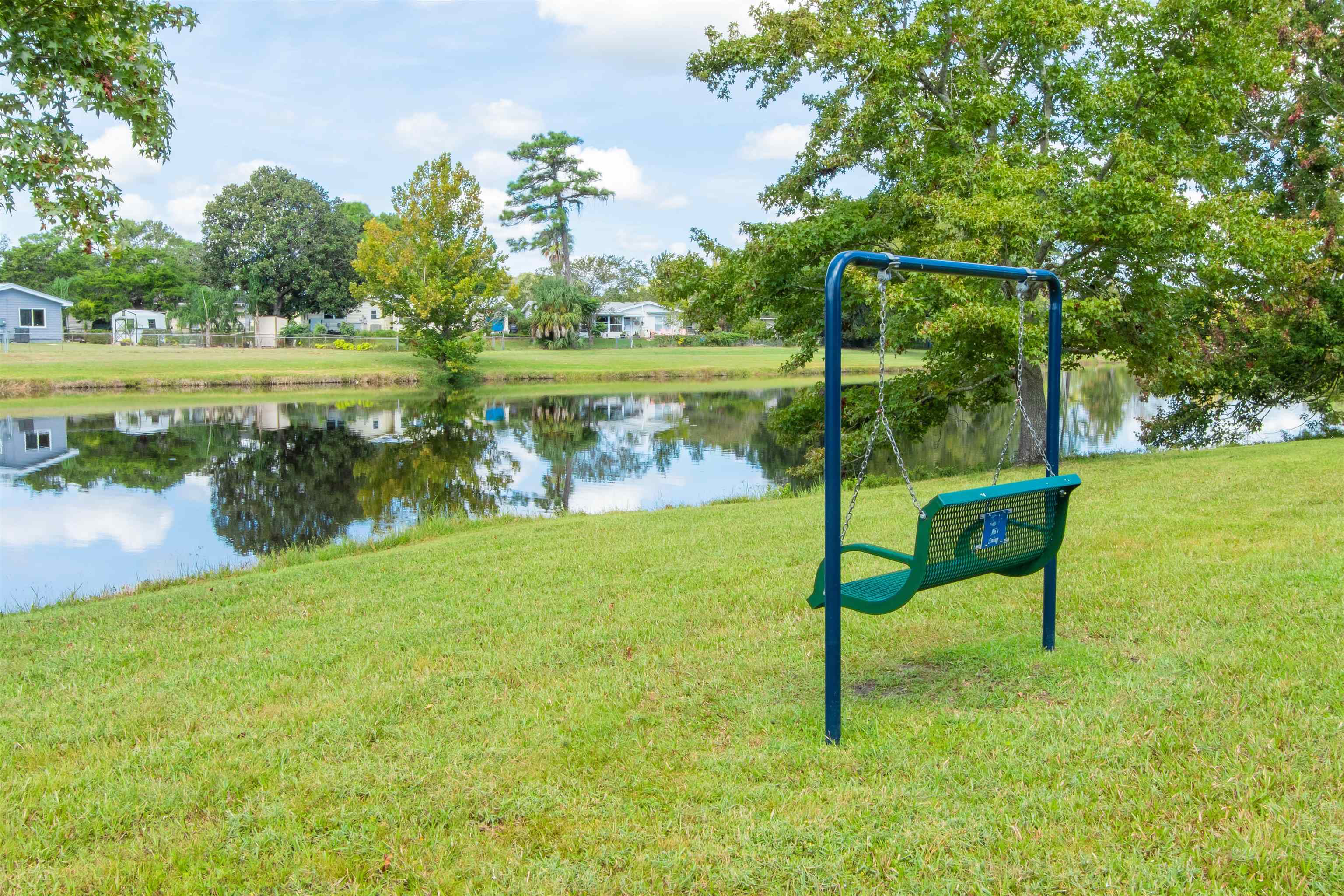 301 Graciela Circle St. Augustine, FL 32086 - Photo 79 of 84 a view of a lake with a bench in the background