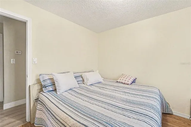 a bedroom with a bed and a night stand