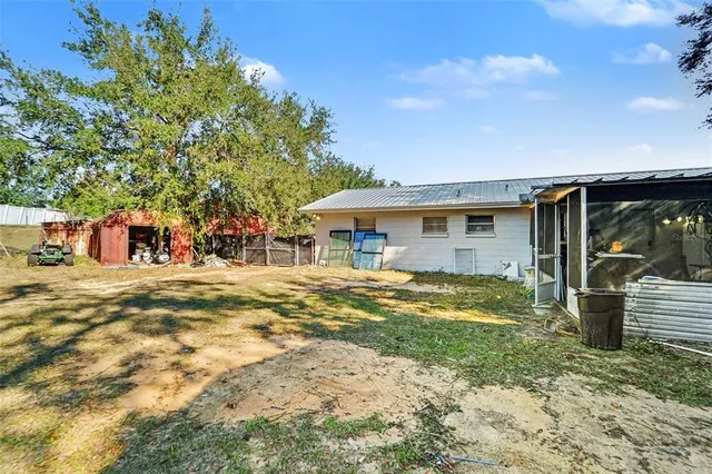 a view of a house with backyard and sitting area