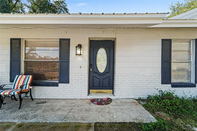 a backyard of a house with table and chairs