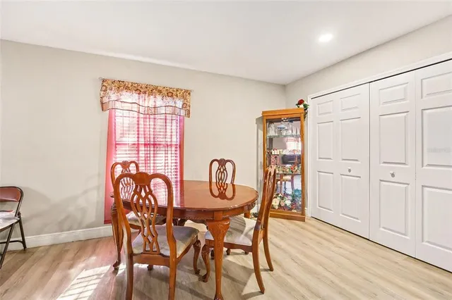 a view of a a dining room with furniture and wooden floor