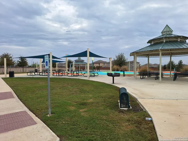 a view of a swimming pool and a yard