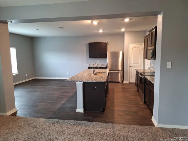 a room with wooden floor and furniture