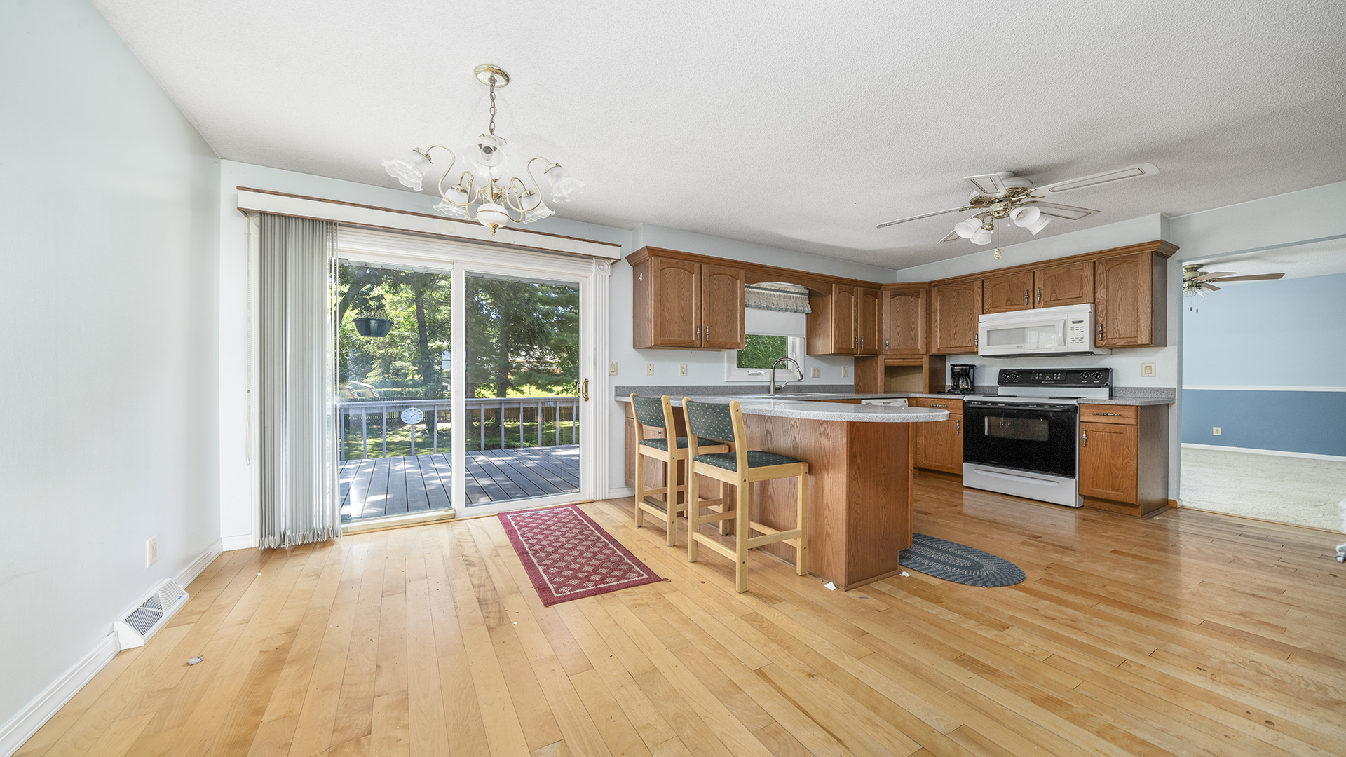 861 Riverside Drive Dixon, IL 61021 - Photo 6 of 33 a open kitchen with granite countertop a stove top oven a sink dishwasher a dining table and chairs with wooden floor