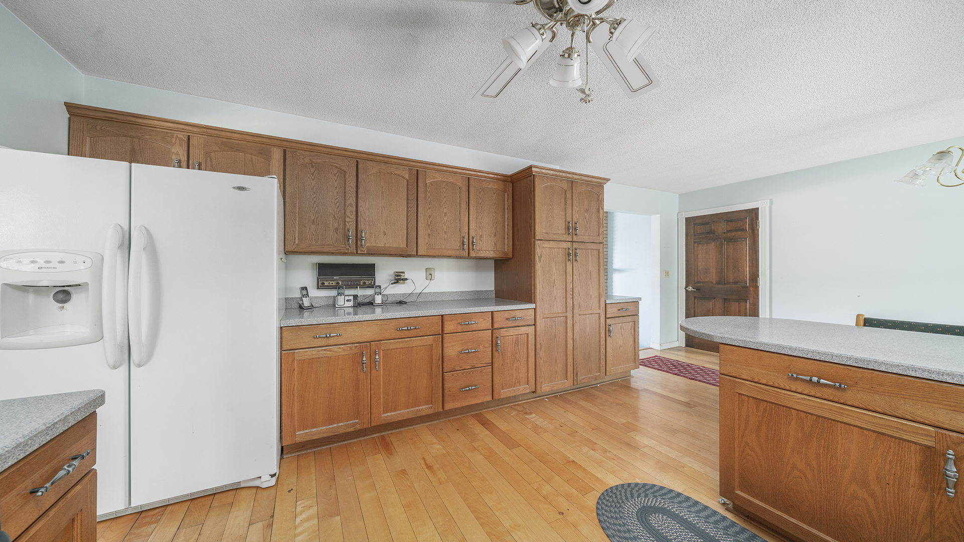 861 Riverside Drive Dixon, IL 61021 - Photo 9 of 33 a kitchen with stainless steel appliances granite countertop a refrigerator a sink and white cabinets