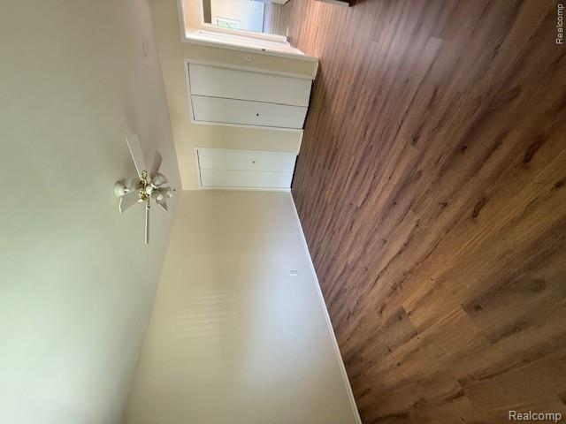 43038 Hanford Road Canton, MI 48187 - Photo 24 of 36 Spacious room featuring wood-finish flooring, two large bi-fold closet doors, a ceiling fan with integrated lighting, and light-toned wall paint
