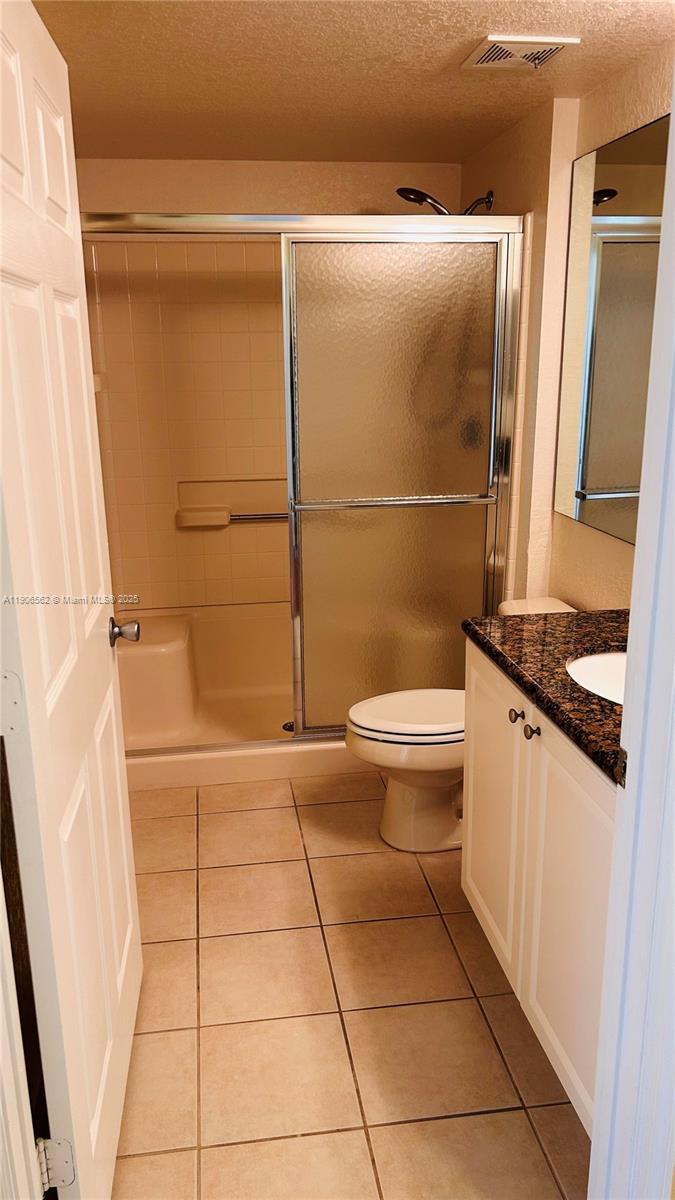 6732 West Sample Road, Unit 6732 Coral Springs, FL 33067 - Photo 20 of 25 a bathroom with a toilet and a shower