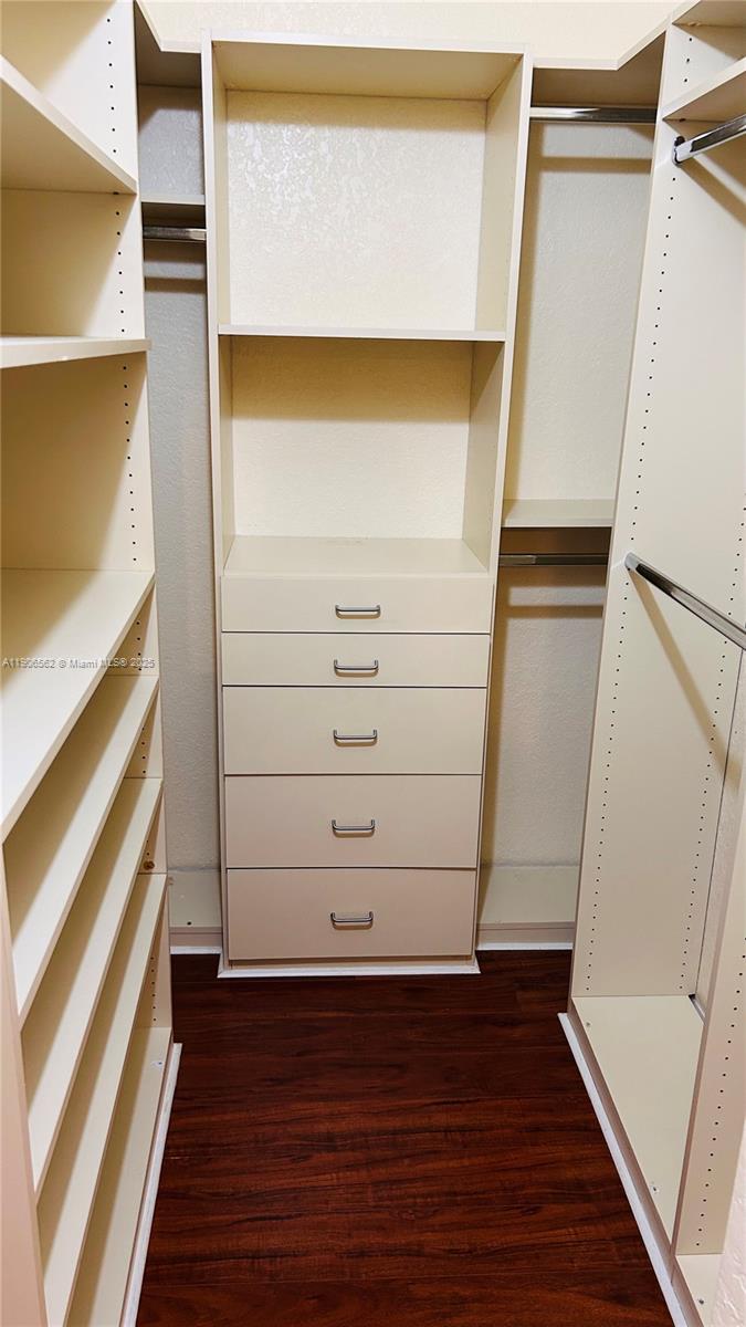 6732 West Sample Road, Unit 6732 Coral Springs, FL 33067 - Photo 22 of 25 a view of walk in closet with wooden floor