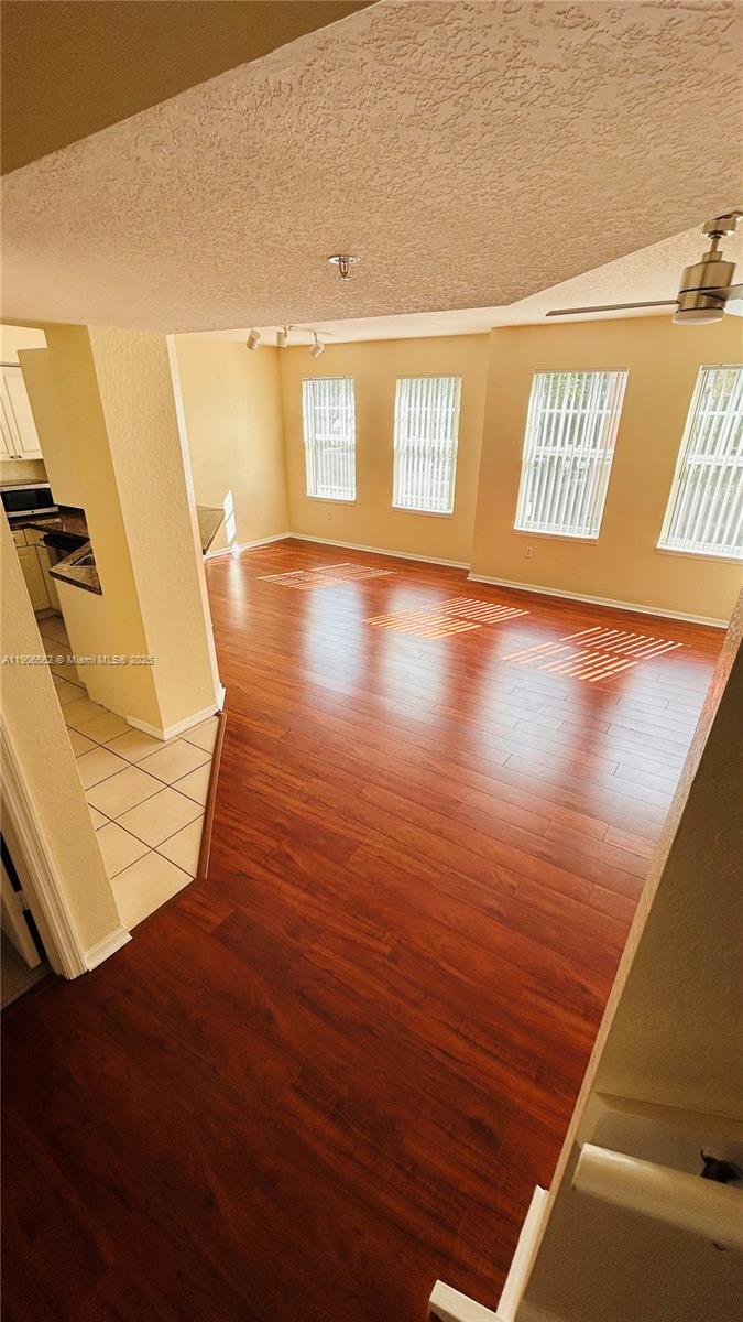 6732 West Sample Road, Unit 6732 Coral Springs, FL 33067 - Photo 6 of 25 a view of an empty room with wooden floor